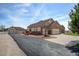 A spacious home featuring a brick and siding exterior, a detached garage, and a long driveway at 16350 Timber Cove St, Hudson, CO 80642