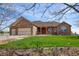 Charming single-Gathering home featuring a brick facade, well-manicured lawn, and a three-car garage at 16350 Timber Cove St, Hudson, CO 80642