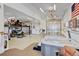 Spacious garage featuring a hot tub, a vehicle lift, and ample room for parking and storage at 16350 Timber Cove St, Hudson, CO 80642