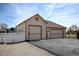 Detached two-car garage featuring neutral siding, paneled doors, and a well-lit exterior at 16350 Timber Cove St, Hudson, CO 80642