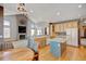 Well-lit kitchen with island and breakfast nook with wood floors and stainless steel appliances at 16350 Timber Cove St, Hudson, CO 80642