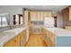 Well-lit kitchen features hardwood floors, white appliances, spacious counters, and ample storage at 16350 Timber Cove St, Hudson, CO 80642