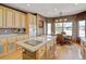 Kitchen features hardwood floors, modern appliances, central island, and large breakfast nook at 16350 Timber Cove St, Hudson, CO 80642