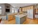 Open kitchen boasts hardwood floors, ample counter space, large island and modern appliances at 16350 Timber Cove St, Hudson, CO 80642
