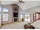 Spacious living room features a fireplace, large windows, and access to the patio at 16350 Timber Cove St, Hudson, CO 80642