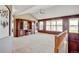 Bright living room with vaulted ceiling, plush carpeting, and a large entertainment center at 16350 Timber Cove St, Hudson, CO 80642
