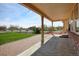 Covered patio overlooking a large yard, perfect for outdoor relaxation and entertaining at 16350 Timber Cove St, Hudson, CO 80642