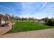Manicured front yard with lush grass and mature landscaping, creating a welcoming entrance at 16350 Timber Cove St, Hudson, CO 80642