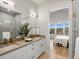 Main bathroom with double vanity, walk-in shower, and views at 3897 Piney Grove St, Evergreen, CO 80439