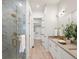Luxury bathroom with marble shower, dual sinks, and gold fixtures at 3897 Piney Grove St, Evergreen, CO 80439