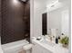 Modern bathroom with dark geometric tile and floating vanity at 3897 Piney Grove St, Evergreen, CO 80439