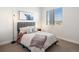 Cozy bedroom with gray bedding and large window at 3897 Piney Grove St, Evergreen, CO 80439