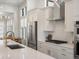 Modern kitchen with stainless steel appliances and white cabinets at 3897 Piney Grove St, Evergreen, CO 80439