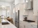 Modern kitchen with stainless steel appliances and white cabinets at 3897 Piney Grove St, Evergreen, CO 80439