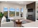 Bright living room with fireplace and mountain views at 3897 Piney Grove St, Evergreen, CO 80439