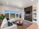 Spacious living room with fireplace and mountain views at 3897 Piney Grove St, Evergreen, CO 80439