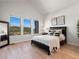 Spacious main bedroom with light wood floors, large windows, and mountain views at 3897 Piney Grove St, Evergreen, CO 80439
