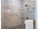Large walk-in shower with marble tile and gold fixtures at 3897 Piney Grove St, Evergreen, CO 80439