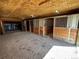 Interior view of a barn featuring horse stalls with wooden panels and metal bars at 11840 Elkhorn Dr, Franktown, CO 80116