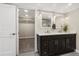 Bathroom featuring double vanity, a walk-in closet and modern fixtures at 11840 Elkhorn Dr, Franktown, CO 80116
