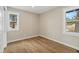 Inviting bedroom boasts hardwood floors and natural light streaming in from two windows creating a warm ambiance at 11840 Elkhorn Dr, Franktown, CO 80116