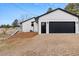 Attached two-car garage with modern black door, fresh paint, and convenient access to the home at 11840 Elkhorn Dr, Franktown, CO 80116