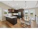 Open concept kitchen with eat in dining and island with quartz countertop at 11840 Elkhorn Dr, Franktown, CO 80116