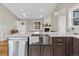Bright kitchen featuring a large island with stainless steel sink and dark wood cabinetry at 11840 Elkhorn Dr, Franktown, CO 80116