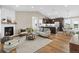 Open concept living room with modern fireplace, stylish furniture, and hardwood floors, perfect for entertaining at 11840 Elkhorn Dr, Franktown, CO 80116