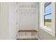 Mudroom with ample storage, including built-in shelves and hooks and a window at 11840 Elkhorn Dr, Franktown, CO 80116