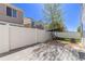 Backyard with a fenced perimeter, covered swing set, brick-lined patio, and well-maintained lawn at 5538 Espana Ct, Denver, CO 80249