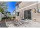Backyard patio area with sliding glass doors, swing set, and privacy fence at 5538 Espana Ct, Denver, CO 80249