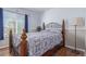 A bedroom featuring a bed with a patterned comforter, wood floors, and a large window at 5538 Espana Ct, Denver, CO 80249