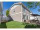 Home exterior featuring a well-maintained backyard with artificial turf and a patio swing, providing a relaxing outdoor space at 5538 Espana Ct, Denver, CO 80249