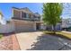 Charming two-story home with a two-car garage and brick-lined driveway, offering a welcoming suburban feel at 5538 Espana Ct, Denver, CO 80249