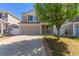 Two-story home with a two-car garage and a well-maintained lawn, showcasing suburban living and easy accessibility at 5538 Espana Ct, Denver, CO 80249