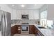 Updated kitchen with stainless steel appliances, tile backsplash, and modern cabinetry at 5538 Espana Ct, Denver, CO 80249