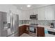 Updated kitchen featuring stainless steel appliances, modern cabinetry, and stone countertops at 5538 Espana Ct, Denver, CO 80249