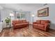 Bright living room with wood flooring, natural light, and comfortable seating at 5538 Espana Ct, Denver, CO 80249