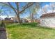 Large backyard features a lush green lawn, mature trees, and a detached garage at 4120 S Lincoln S St, Englewood, CO 80113