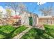 Backyard boasts a manicured lawn, an outdoor dining set, and a detached garage at 4120 S Lincoln S St, Englewood, CO 80113