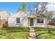 Charming single story home with a green door, pathway, and well-manicured lawn and garden at 4120 S Lincoln S St, Englewood, CO 80113