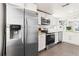 Beautiful kitchen featuring stainless steel appliances, white cabinets, and granite countertops at 4120 S Lincoln S St, Englewood, CO 80113