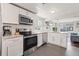 Kitchen with stainless steel appliances and a view into the dining and living areas at 4120 S Lincoln S St, Englewood, CO 80113