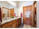 Beautiful bathroom with double vanity, granite countertops and wood-look tile floors at 14434 W 88Th Dr # B, Arvada, CO 80005