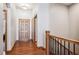 Welcoming home entryway with hardwood floors, a wooden door, and a staircase at 14434 W 88Th Dr # B, Arvada, CO 80005