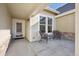 Inviting front porch with seating area and stylish exterior featuring stone accents and a secure storm door at 14434 W 88Th Dr # B, Arvada, CO 80005