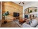 Living room with a wood accent wall and a stone fireplace at 14434 W 88Th Dr # B, Arvada, CO 80005