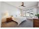 Cozy main bedroom with neutral tones, a ceiling fan, and natural light from the window at 14434 W 88Th Dr # B, Arvada, CO 80005