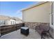 Relaxing patio with stone accents, outdoor seating, and a fire pit with a view of a neighbor's home at 14434 W 88Th Dr # B, Arvada, CO 80005